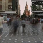 a blurry photo of people walking down a street